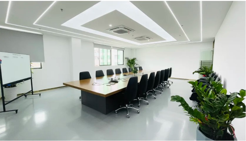 a long table and group of chairs in a meeting room