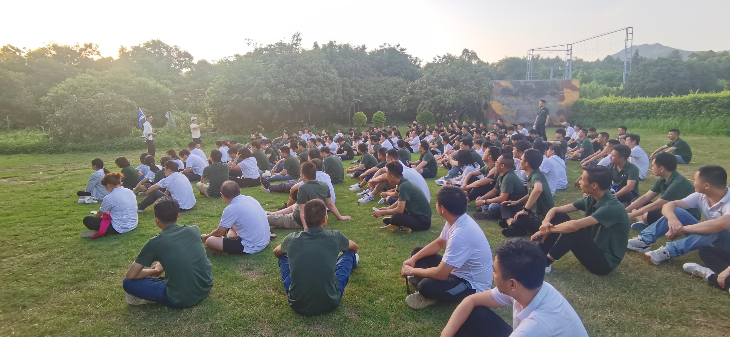 a group of han technology employees on a grass